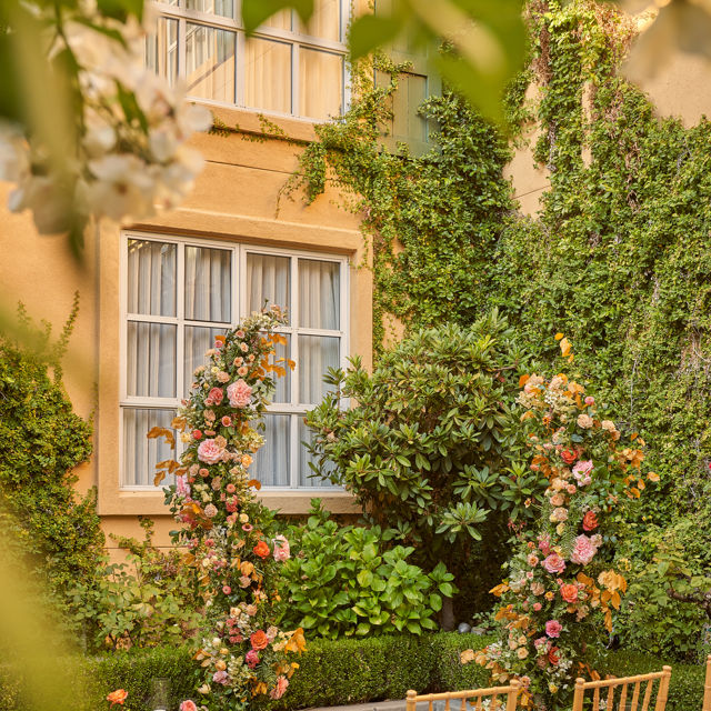 Floral Arch With Chairs Outside